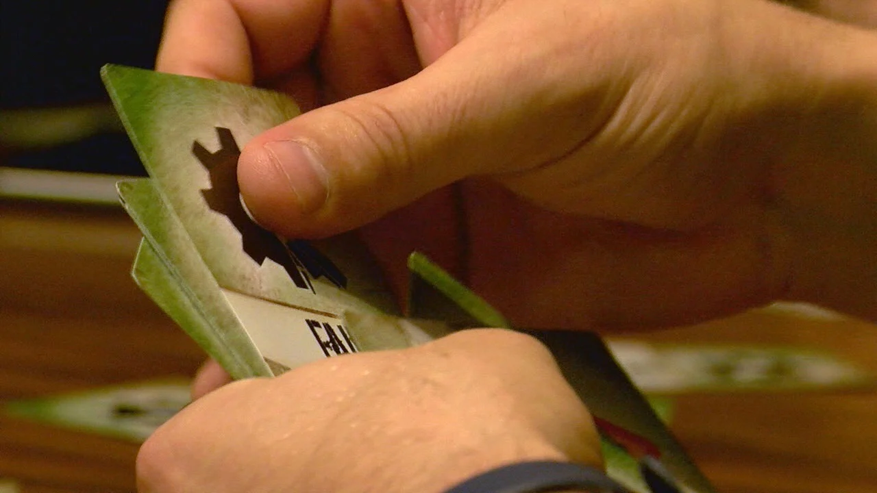 Close-up of a player holding a FAIL card during a round of Rescue Mac.